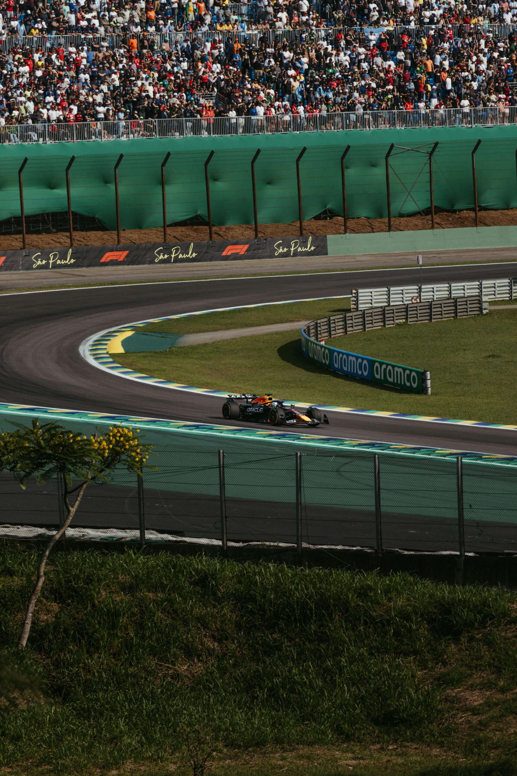 A thrilling Formula 1 race car speeds through the iconic Interlagos Circuit in São Paulo, Brazil.