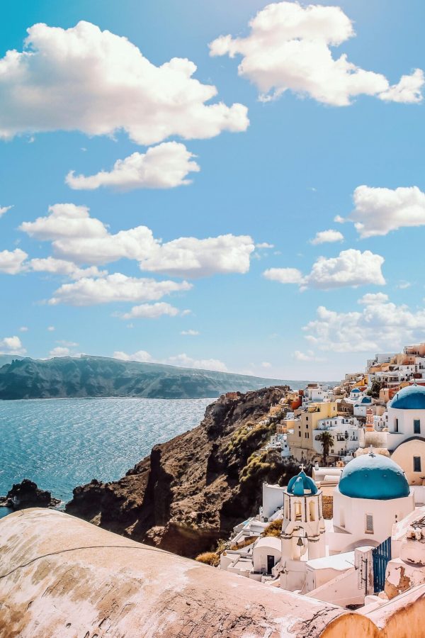 Captivating view of Santorini's famous blue-domed buildings under a vibrant sky.